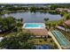 Aerial view showing community pool, lake, and recreational areas at 2677 Pine Ridge N Way # B2, Palm Harbor, FL 34684