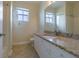 Bathroom with granite countertop, white cabinets, and tiled floors at 2724 Via Murano # 631, Clearwater, FL 33764