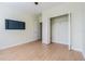 Bedroom with wood floors, ceiling fan, and arched windows at 2724 Via Murano # 631, Clearwater, FL 33764