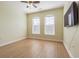 Bedroom with wood floors, ceiling fan, and arched windows at 2724 Via Murano # 631, Clearwater, FL 33764