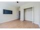 Bedroom with wood floors, ceiling fan, and large closet at 2724 Via Murano # 631, Clearwater, FL 33764