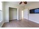 Bedroom with wood floors, ceiling fan, and large closet at 2724 Via Murano # 631, Clearwater, FL 33764