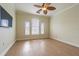 Bright bedroom with wood floors, ceiling fan, and arched windows at 2724 Via Murano # 631, Clearwater, FL 33764