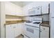 Well-equipped kitchen with white cabinets and granite at 2724 Via Murano # 631, Clearwater, FL 33764