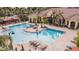 Large community pool with volleyball net and lounge chairs at 2724 Via Murano # 631, Clearwater, FL 33764