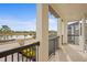 Spacious balcony boasts scenic views of the lake and surrounding landscape at 28475 Marsciano Ln, Wesley Chapel, FL 33543