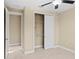 Bedroom with a closet and access to another room at 28475 Marsciano Ln, Wesley Chapel, FL 33543