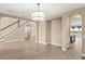 Bright dining room with hardwood floors, staircase view, and arched doorways at 28475 Marsciano Ln, Wesley Chapel, FL 33543