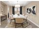 Elegant dining room features a marble table, chandelier, and stylish decor at 28475 Marsciano Ln, Wesley Chapel, FL 33543