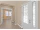 Entryway with glass french doors leading to dining room at 28475 Marsciano Ln, Wesley Chapel, FL 33543