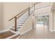 Elegant staircase in a two-story entryway with tile floors at 28475 Marsciano Ln, Wesley Chapel, FL 33543