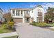 Two-story home with stone accents and a three-car garage at 28475 Marsciano Ln, Wesley Chapel, FL 33543