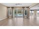 Gathering room with sliding doors leading to the pool and screened patio at 28475 Marsciano Ln, Wesley Chapel, FL 33543