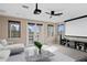 Spacious media room with projector, screen, and access to balcony at 28475 Marsciano Ln, Wesley Chapel, FL 33543