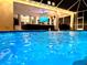 Night view of illuminated pool and patio area at 28475 Marsciano Ln, Wesley Chapel, FL 33543