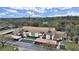 Aerial view of condo building, showing building exterior, landscaping, and parking at 2866 Countrybrook Dr # 15, Palm Harbor, FL 34684