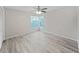 Bright bedroom with wood-look floors and ceiling fan at 2866 Countrybrook Dr # 15, Palm Harbor, FL 34684