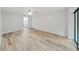 Main bedroom with wood-look floors and access to a balcony at 2866 Countrybrook Dr # 15, Palm Harbor, FL 34684
