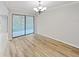 Dining room features wood-look floors and a sliding glass door at 2866 Countrybrook Dr # 15, Palm Harbor, FL 34684
