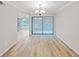 Bright dining room with wood-look floors and access to a screened-in patio at 2866 Countrybrook Dr # 15, Palm Harbor, FL 34684