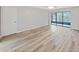Spacious living room with wood-look floors and sliding glass doors at 2866 Countrybrook Dr # 15, Palm Harbor, FL 34684