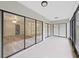 Bright screened porch with view of backyard and sliding glass doors at 2866 Countrybrook Dr # 15, Palm Harbor, FL 34684