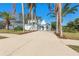 Two-story light blue house with a teal front door and palm trees at 2993 Shannon Cir, Palm Harbor, FL 34684