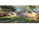 Large backyard with grassy area and wooden fence at 301 3Rd Sw Ave, Largo, FL 33770