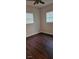 Bright bedroom with dark wood floors and two windows at 301 3Rd Sw Ave, Largo, FL 33770