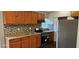 Cozy kitchen with wood cabinets and tile backsplash at 301 3Rd Sw Ave, Largo, FL 33770