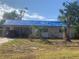 One-story house with tarp-covered roof, needs repairs at 3120 Smith Ave, Bradenton, FL 34207