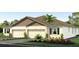 Two-story house with two-car garage and landscaped yard at 31548 Ancient Sage Rd, Wesley Chapel, FL 33545