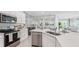 Open concept kitchen with large island and views to living area at 31548 Ancient Sage Rd, Wesley Chapel, FL 33545