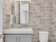 Stylish powder room with a modern vanity and elegant wallpaper at 3213 W Fair Oaks Ave, Tampa, FL 33611