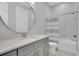 Clean bathroom with gray vanity, tub, and shower at 3213 W Fair Oaks Ave, Tampa, FL 33611
