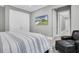Serene bedroom with a comfy seating area and large TV at 3213 W Fair Oaks Ave, Tampa, FL 33611