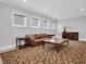 Spacious bonus room with leather sofa and patterned rug at 3213 W Fair Oaks Ave, Tampa, FL 33611