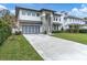 Modern two-story house with clean lines, light-colored facade and two-car garage at 3213 W Fair Oaks Ave, Tampa, FL 33611
