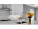 Modern kitchen with white cabinets, stainless steel appliances, and a large island at 3213 W Fair Oaks Ave, Tampa, FL 33611