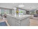 Modern kitchen with large island, quartz countertops, and stainless steel appliances at 3213 W Fair Oaks Ave, Tampa, FL 33611