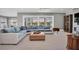 Spacious living room featuring a large sectional sofa and access to the backyard at 3213 W Fair Oaks Ave, Tampa, FL 33611