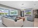 Open living area with sectional sofa, fireplace, and large TV at 3213 W Fair Oaks Ave, Tampa, FL 33611