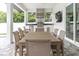 Outdoor kitchen with built-in grill, large dining table, and ceiling fan at 3213 W Fair Oaks Ave, Tampa, FL 33611