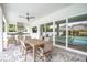 Covered patio with dining area, outdoor kitchen, and pool view at 3213 W Fair Oaks Ave, Tampa, FL 33611