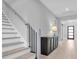 Modern staircase with black balusters and light wood treads at 3213 W Fair Oaks Ave, Tampa, FL 33611