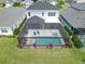 Aerial view of home with pool and screen enclosure at 3322 Woodmont Dr, Parrish, FL 34219