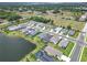 Aerial view of houses and lake in community at 3322 Woodmont Dr, Parrish, FL 34219
