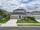 Two-story home with gray siding, neutral accents, and a two-car garage at 3322 Woodmont Dr, Parrish, FL 34219