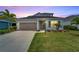 Two-story house with gray siding, landscaping, and a welcoming front porch at 3322 Woodmont Dr, Parrish, FL 34219