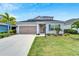 Two-story house with gray siding, landscaping, and a two-car garage at 3322 Woodmont Dr, Parrish, FL 34219